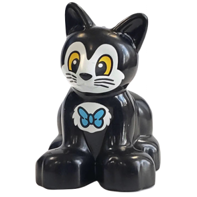 duplo cat kitten sitting with yellow eyes and white face and chest with bow tie pattern