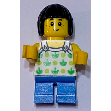 child - girl white halter top with green apples and lime spots dark azure short legs black bob cut hair freckles
