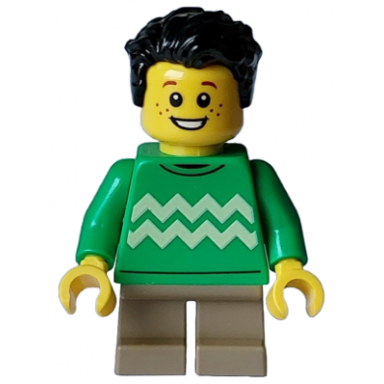 child - boy bright green sweater with bright light yellow zigzag lines dark tan short legs black tousled hair freckles