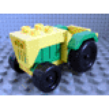 yellow duplo farm tractor with black wheels green engine and fenders and yellow hitch