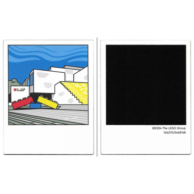 white plastic polaroid photo with white lego house building with red yellow and blue bricks and black square on back pattern