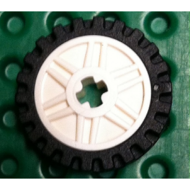 wheel 18mm d x 8mm with fake bolts and shallow spokes and axle hole with black tire 24mm d x 7mm offset tread - band around center of tread 56903 61254