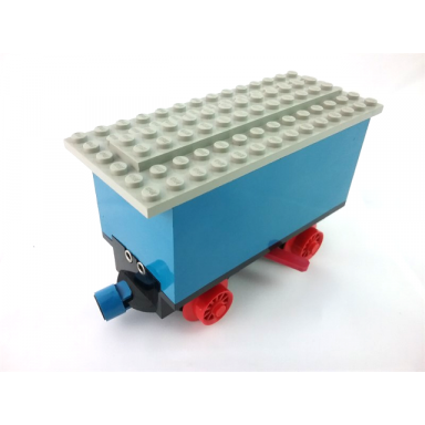 blue train battery box car with two contact holes red switch lever blue and red magnets red wheels and light gray roof