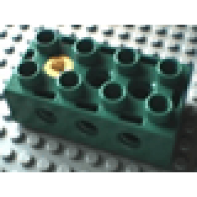 green duplo toolo brick 2 x 4 with holes on sides and top and 1 screw in top