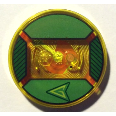 trans-yellow dimensions toy tag 4 x 4 x 2 3 with 2 studs and trans-orange bottom with stylized lime capital letter g in black arrowhead on green background pattern green arrow
