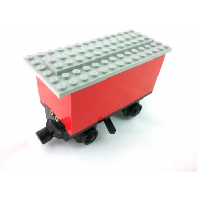 red train battery box car with three contact holes black switch lever black magnets black wheels and light gray roof