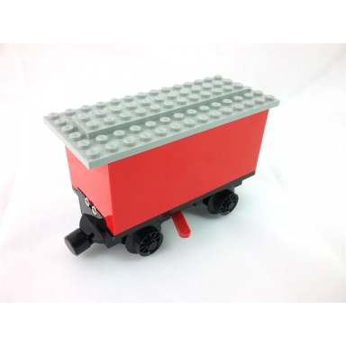 red train battery box car with three contact holes red switch lever black magnets black wheels and light gray roof